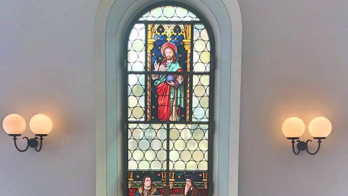 Ein Kirchenaltar vor einem buntglasfenster