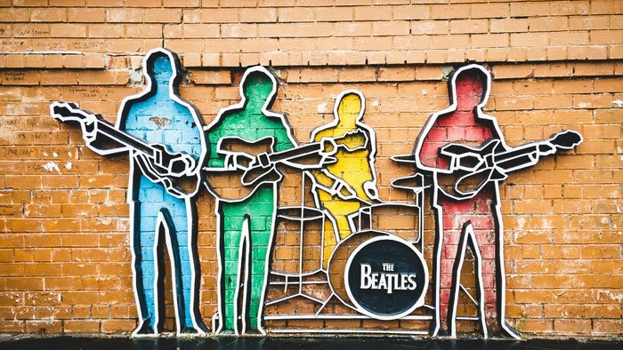 Umrisse der Beatles vor einer Mauer