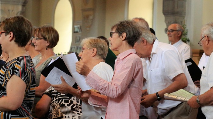 Eine Gruppe von Menschen singt in einem Kirchenraum