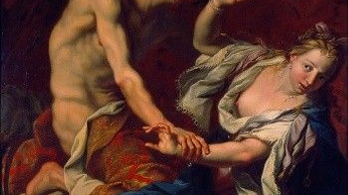 En mand og en kvinde i klassisk dragt, hvor manden holder kvindens hånd, begge i en dramatisk pose.