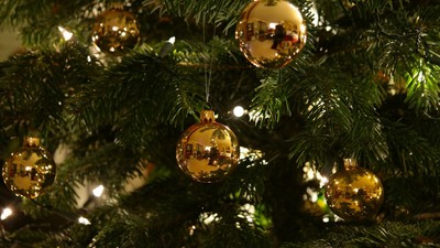 En juletree med guldfarvede pynt.