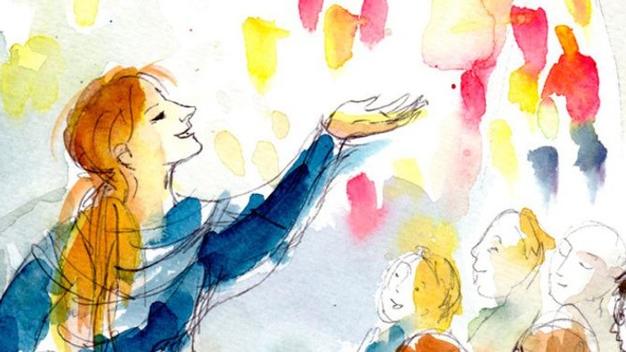 Eine Frau spricht zu einer Gruppe von Menschen, während bunte Konfetti um sie herum herabrieselt.