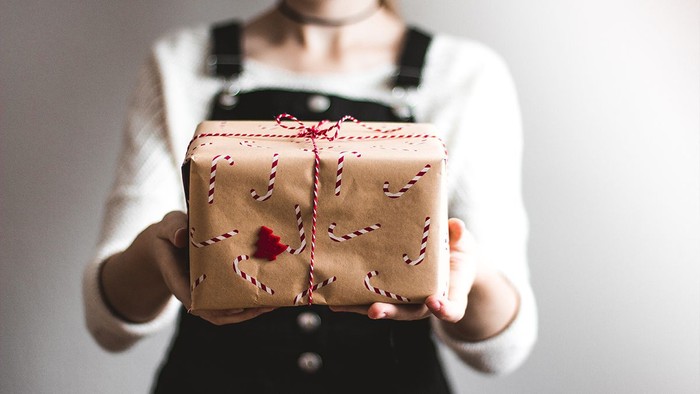 Person überreicht ein Geschenk