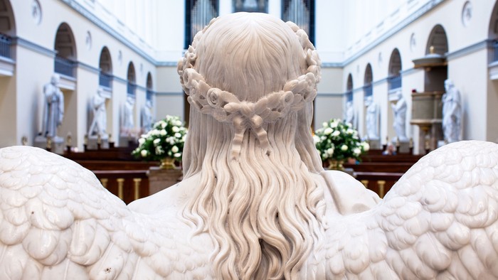 En engelsk statue med vinger i en kirke.