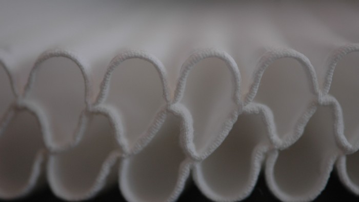 En række hvide papirringe opstillet i en kurveret mønster.