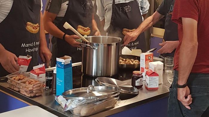 Fire mænd koker sammen i en professionel køkken.