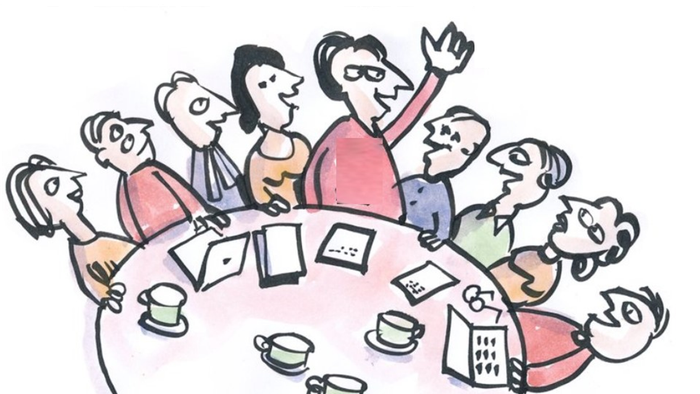 En gruppe af mennesker sidder om en bord og diskuterer.