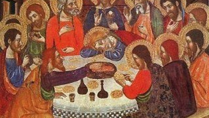 Billedet viser en religiøs scene med flere skikkelser om en bord.