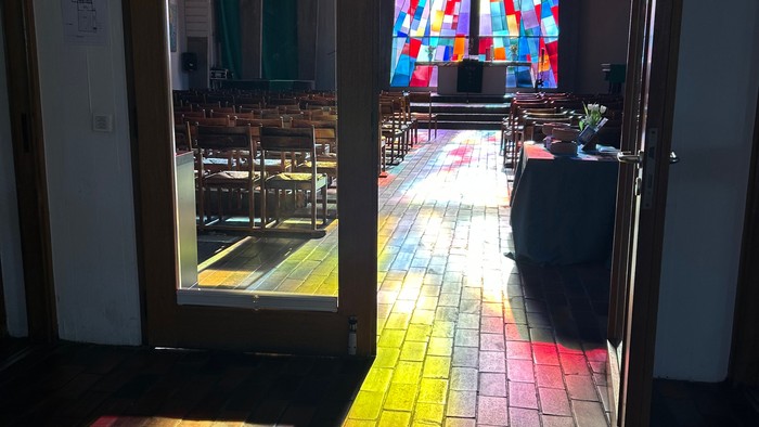 Bunte Glasfenster in Kirche, Sonnenlicht durch Strahlen auf Boden