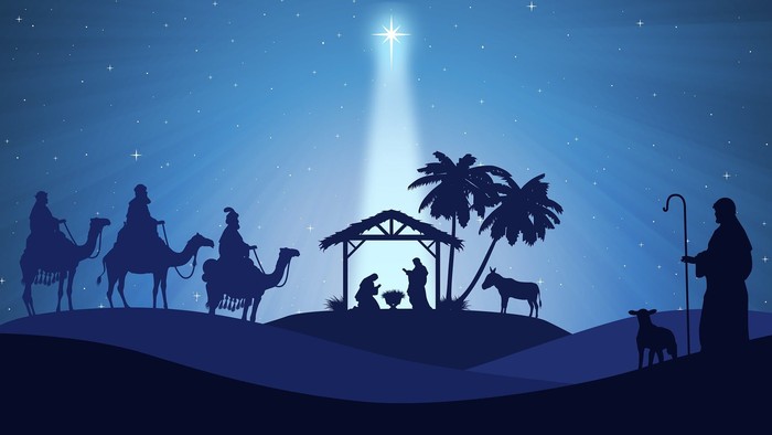 „Krippenszene als Silhouette unter sternenklarer Nacht mit den Weisen, dem Jesuskind und Tieren.“