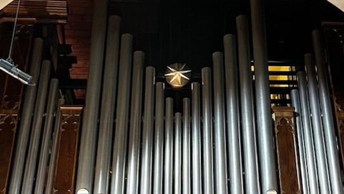 Large pipe organ in a grand building.