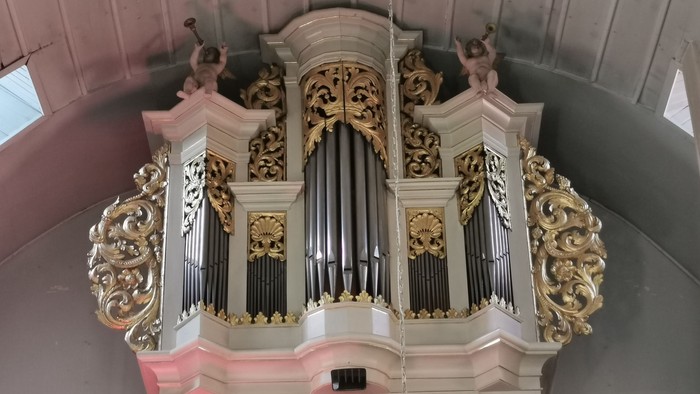 Prächtige Kirchenorgel mit aufwendigen Verzierungen und Figuren.