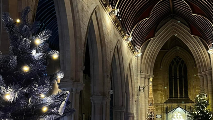 Church interior with Christmas tree and stained glass windows