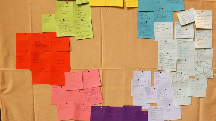 Bunte Klebezettel in Kreisform auf braunem Stoff