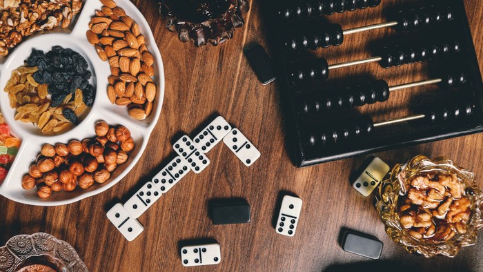 a table with nuts, snacks, dominoes and an abacus