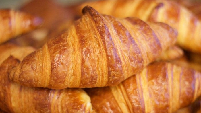 A pile of golden brown croissants.