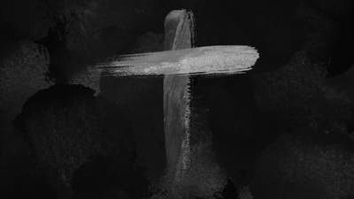 A simple cross drawn in white chalk on a dark background.