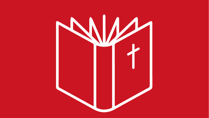 Billedet viser en åben bibel med et kors i midten på rød baggrund
