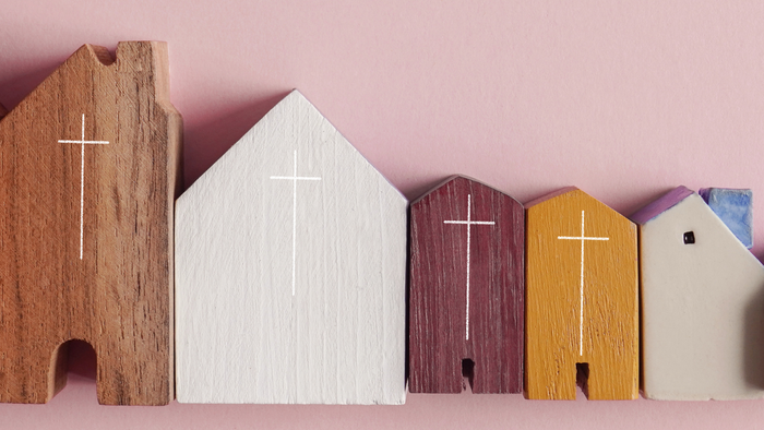 Five wooden church models in different colors with crosses on them