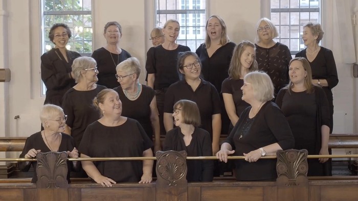 En gruppe kvindelige kormedlemmer, der optræder sammen i en kirke.