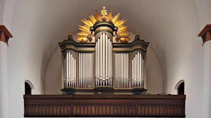Orgelet er placeret i et hvidt kapel med guld akcent.