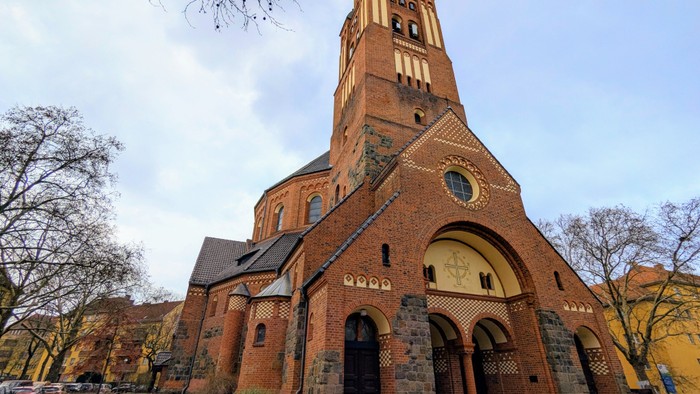 Große Ziegelkirche mit hohem Turm und Rundbogenfenster