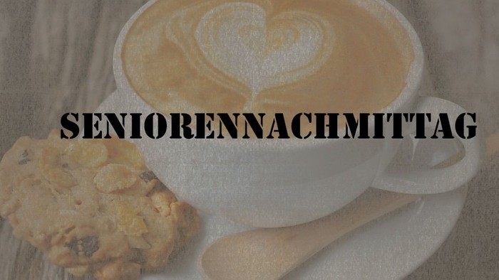 Ein Latte Macchiato mit Herzverzierung und ein Keks auf einem Teller