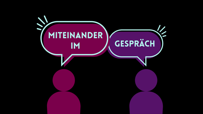 Zwei Personen in Lila unterhalten sich über Miteinander im Gespräch