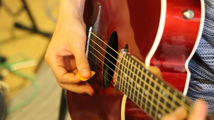 A person playing an electric guitar.