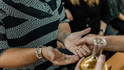 A person receives henna tattoo on their hand.