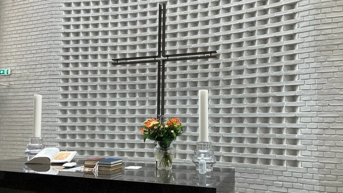 Alter med kors og blomster i kirke