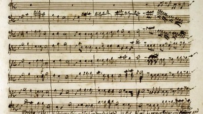 Ein handgeschriebenes Notenblatt mit musikalischer Notation.