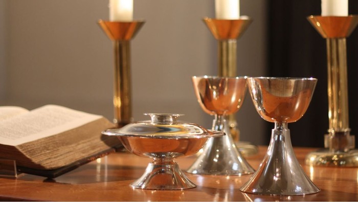 Ein Tisch mit Kerzen, einem Buch und Gläsern