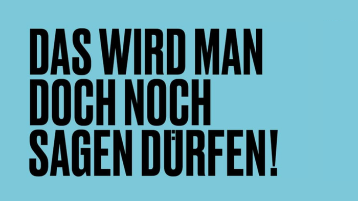 Das Bild zeigt einen blauen Hintergrund mit fett gedrucktem, schwarzem und weißem Text auf Deutsch, der lautet: *„Das wird man doch noch sagen dürfen!“* und *„Nein. Nie wieder ist jetzt!“*