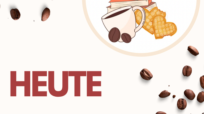 Das Bild zeigt ein Buchercafé mit Kaffee, Büchern und einem Keks