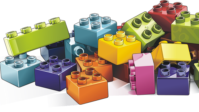 Bunte Lego-Bausteine in verschiedenen Formen und Größen auf schwarzem Hintergrund.