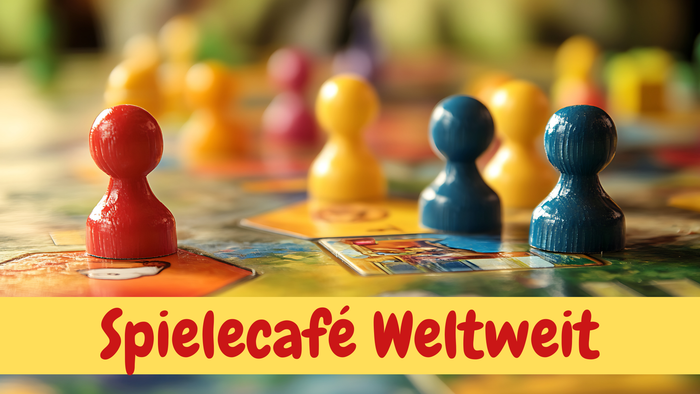 Man sieht ein Spielbrett mit bunten Spielfiguren und dem Zug Spielecafé Weltweit.