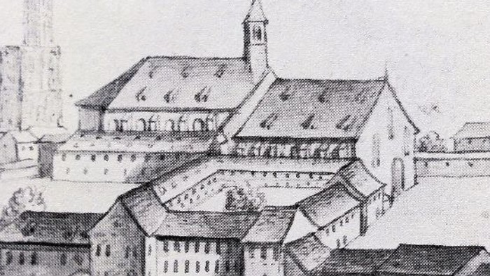 Dessin architectural de ville médiévale avec église et bâtiments.