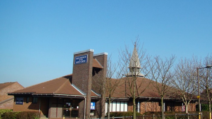 Building with sign, trees, and clear sky