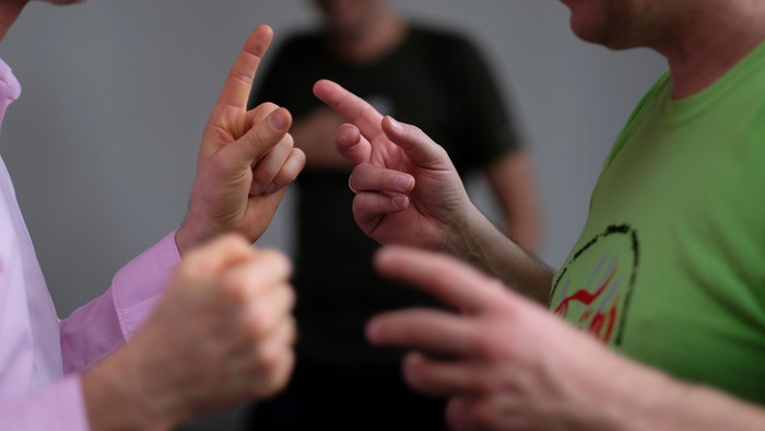 Drei Personen reichen sich die Hände