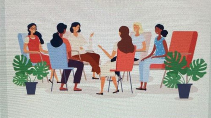 Eine vielfältige Gruppe von Menschen in einem lockeren Treffen oder einer Therapiesitzung, umgeben von Pflanzen.