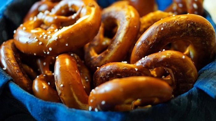Frische, goldbraune Laugenbrezeln in einem Korb – herzhaftes Gebäck für den Frühschoppen der Evangelischen Kirchengemeinde Neureut.