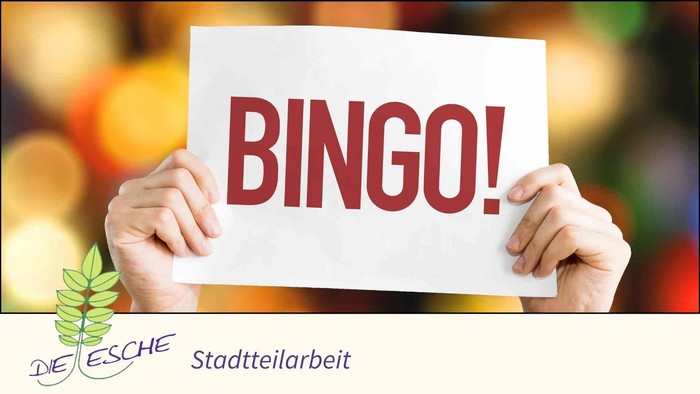 Hände halten ein „BINGO!“-Schild mit dem Logo „Die Esche Stadtteilarbeit“ im Hintergrund.