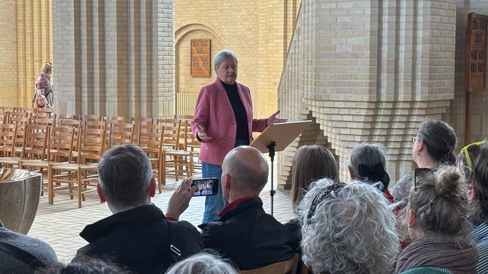 En præst taler til en forsamling i kirke.