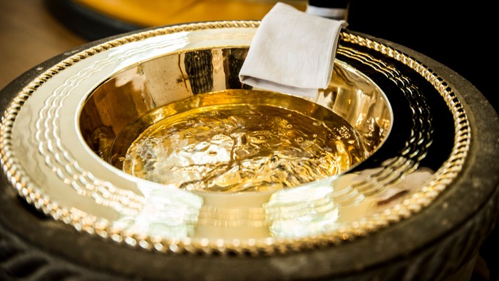 En smuk og poleret sølvbåde med en hvid klæde og en skøn skål.