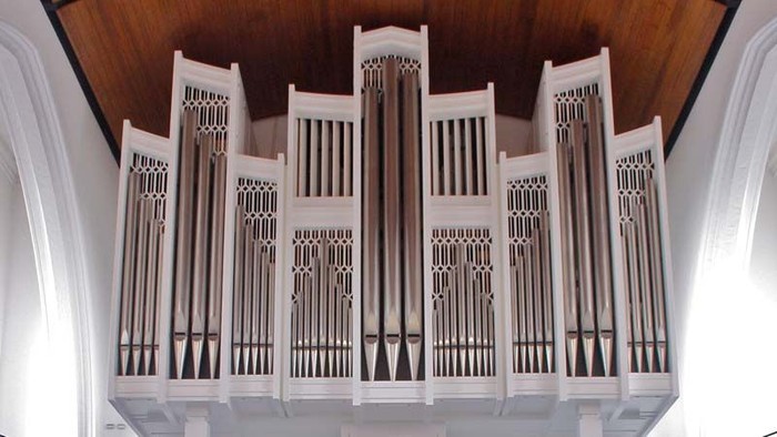 Ein weißes Kirchenorgel mit Holzdecke