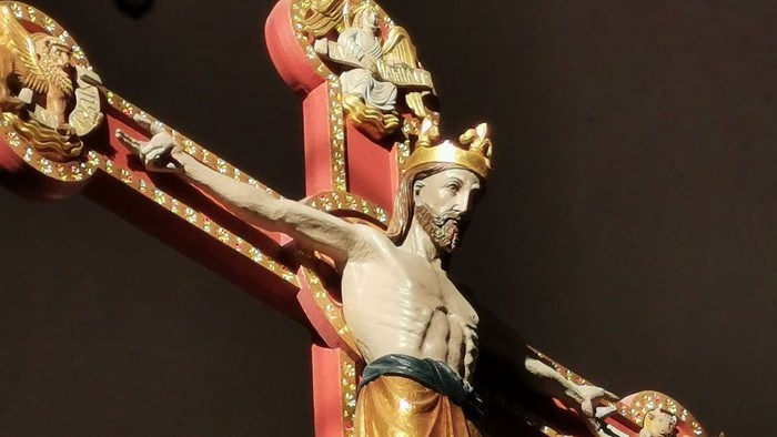 Die Statue zeigt Jesus Christus am Kreuz mit goldenen Akzenten