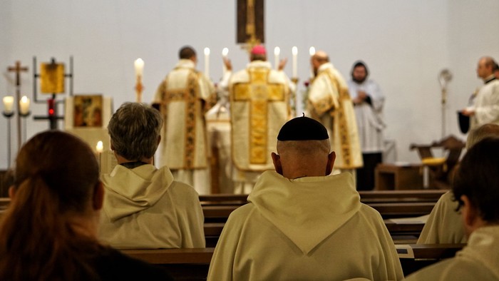 Gottesdienst in einer Kirche, Priester in weißen Gewändern
