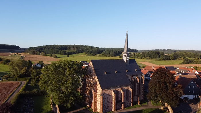 Kirchengebäude in ländlicher Umgebung mit Feldern und Wäldern