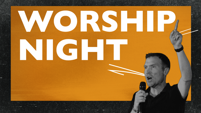 A man speaking passionately into a microphone during a vibrant 